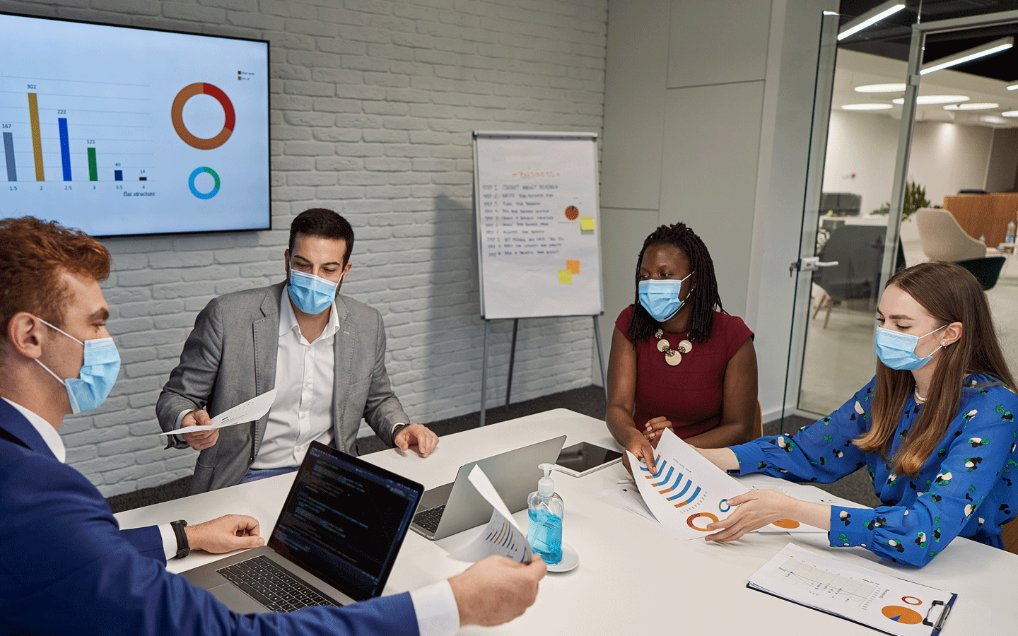 office people in meeting wearing masks