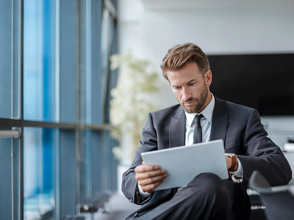 Lawyer looking at competitive intelligence on a tablet