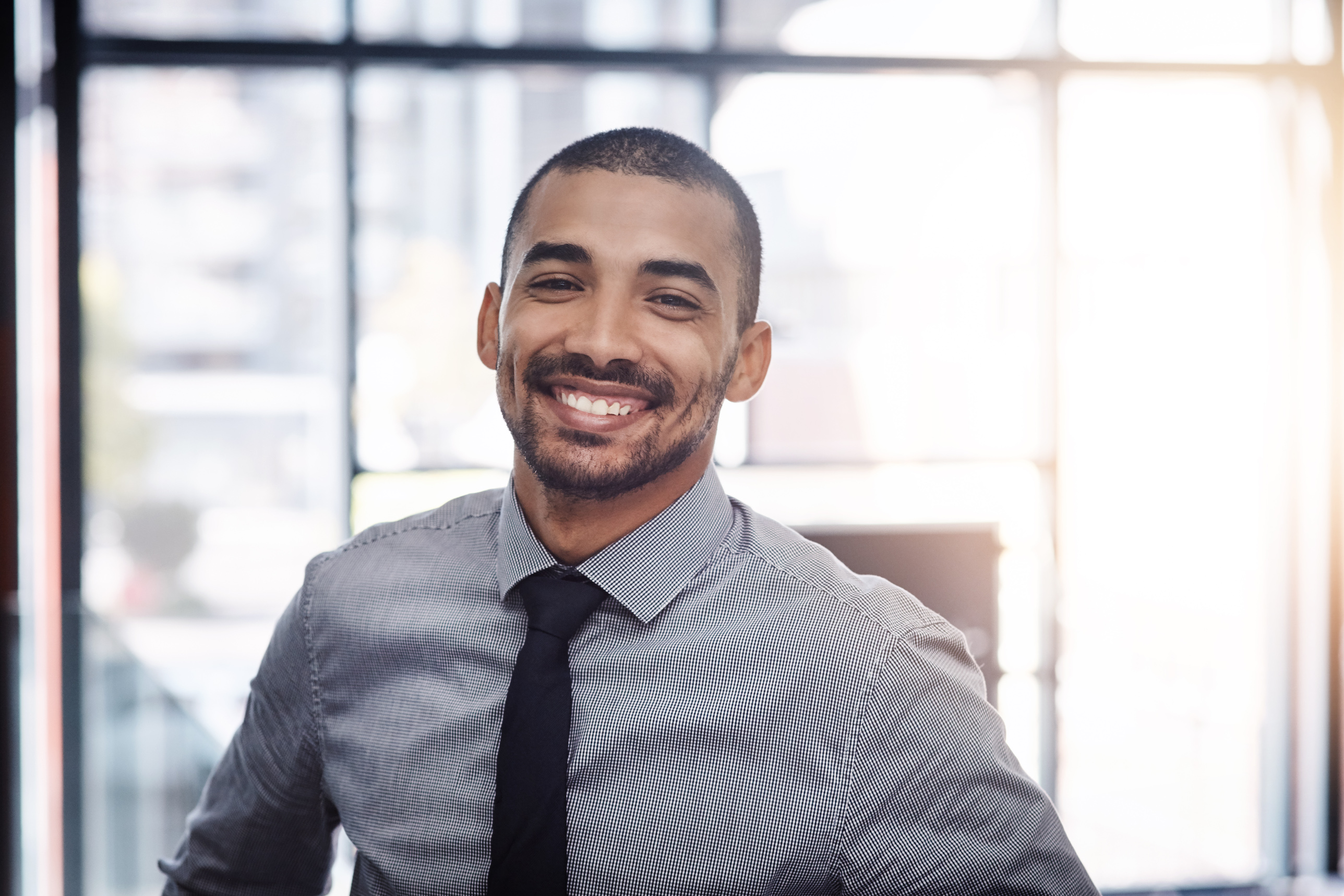 Man smiling in business setting