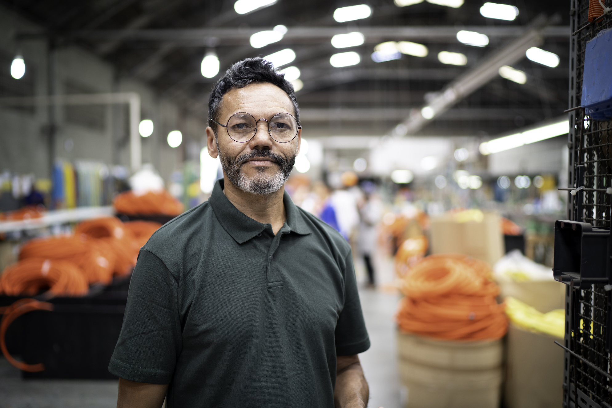 Man smiling in manufacturing setting