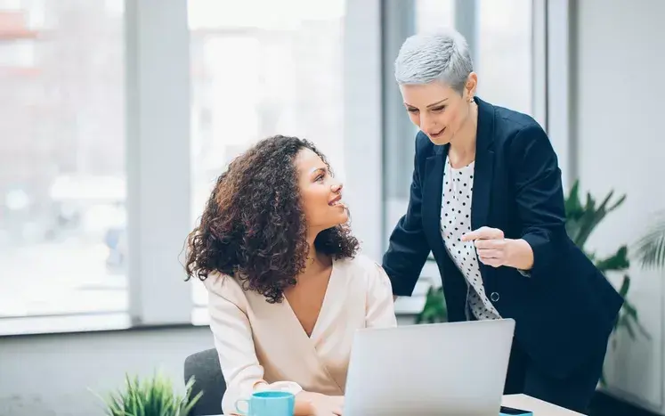 Two professionals discussing the differences between proactive and reactive governance.