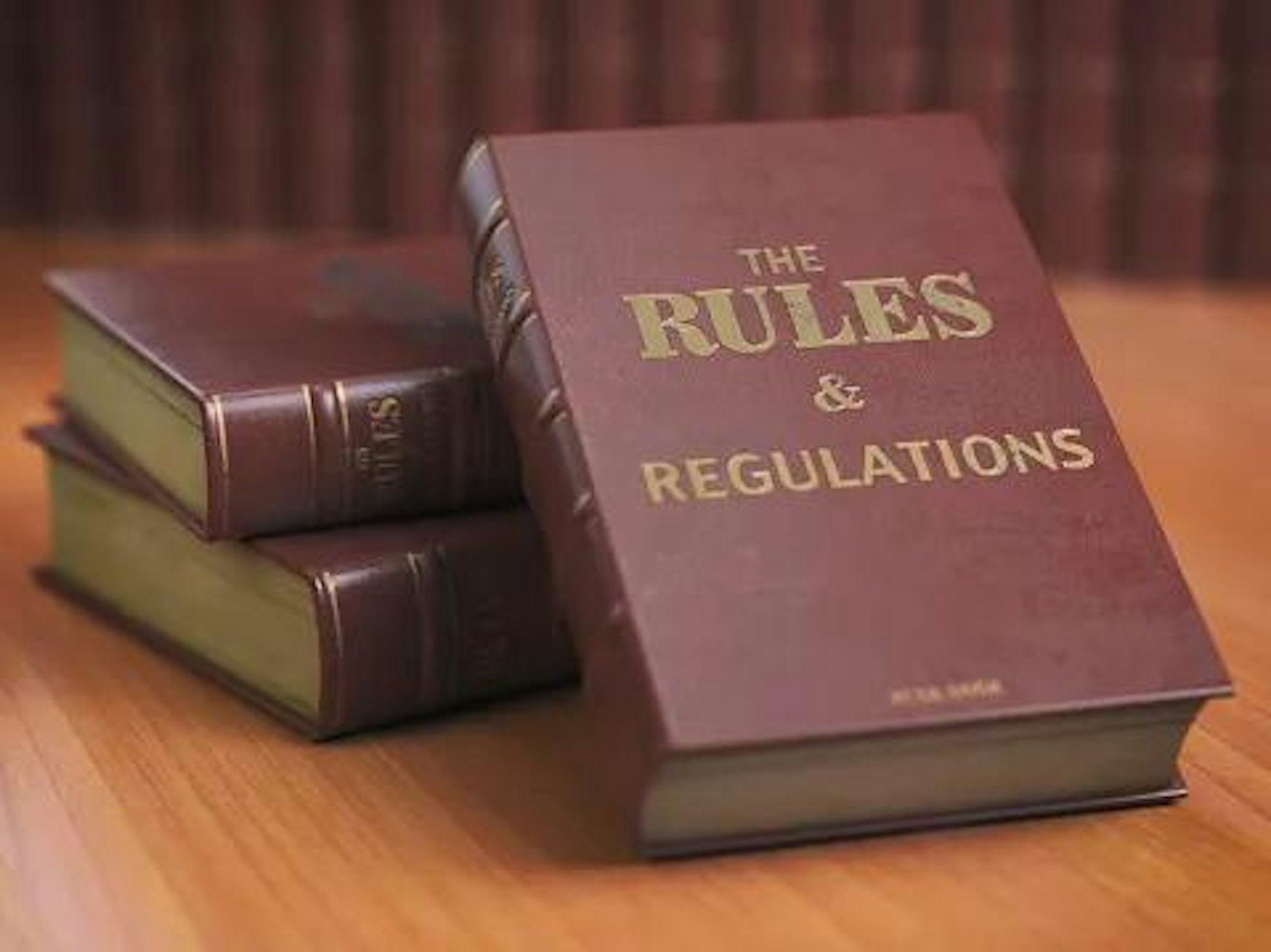 Book with text saying "rules and regulations"