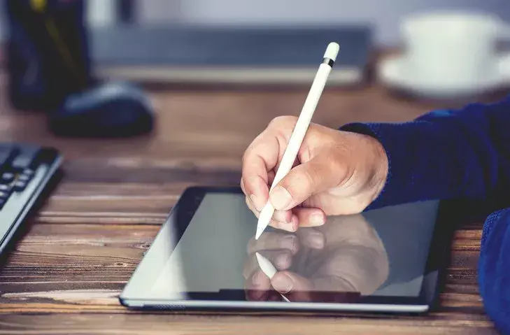 person writing minutes at school boards meeting