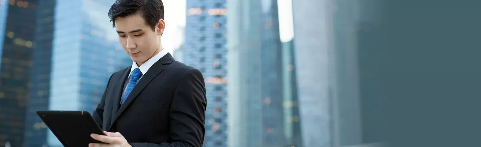 A CISO checking the guide for successful security objectives on his tablet.