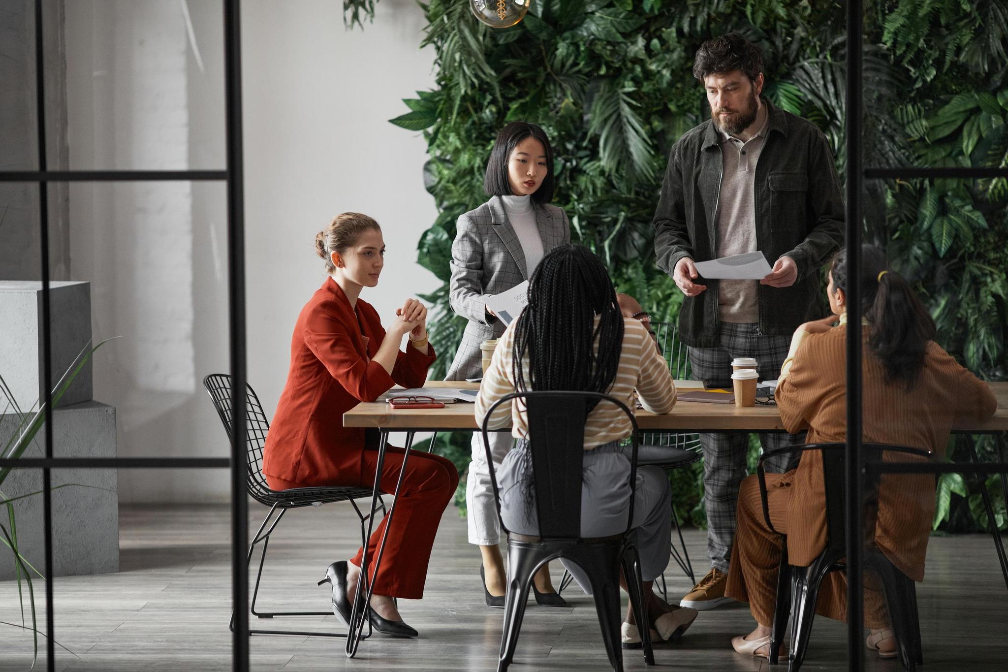 Professionals sit in board room discussing an uprising proxy fight
