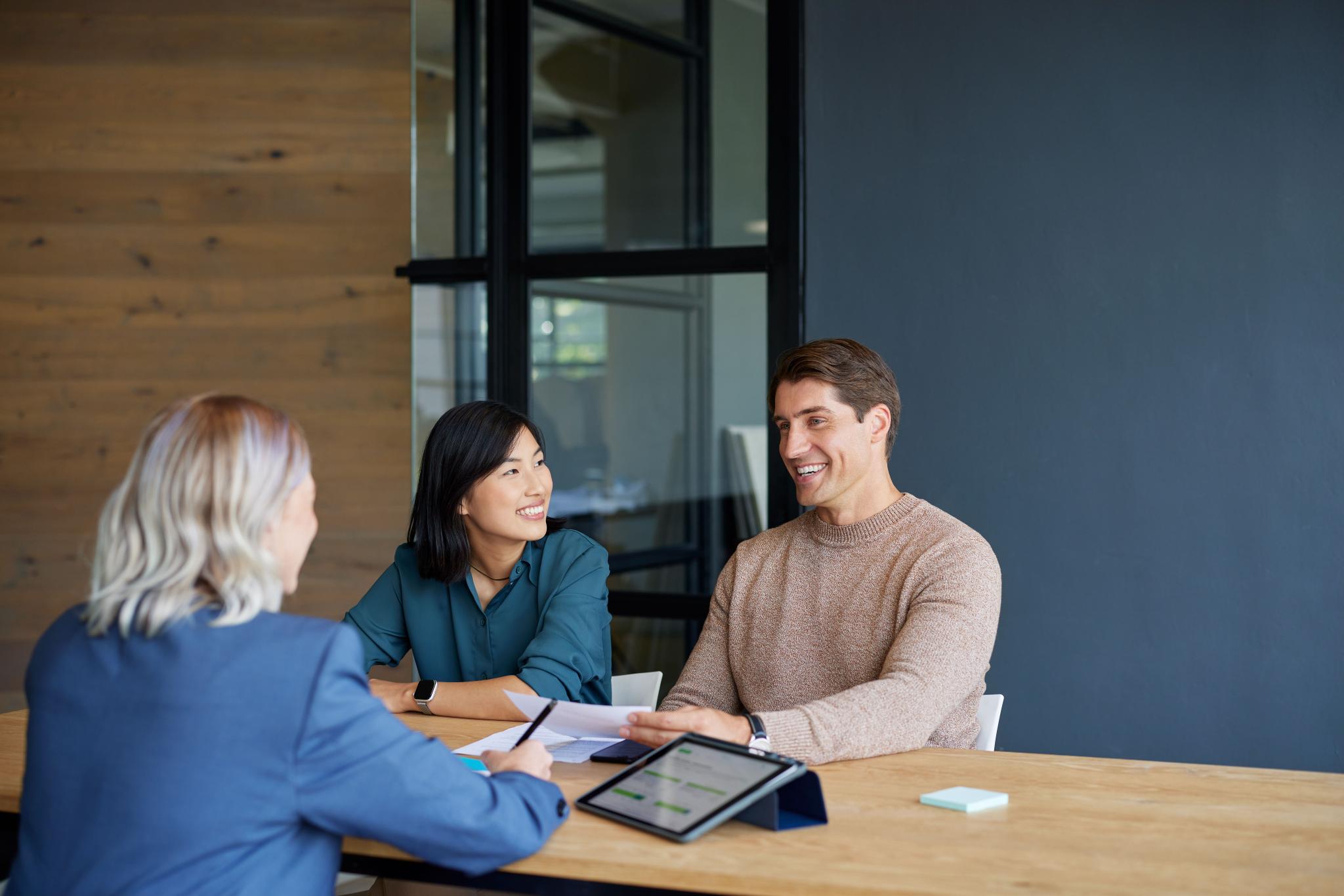 couple meeting compliance advisor in office