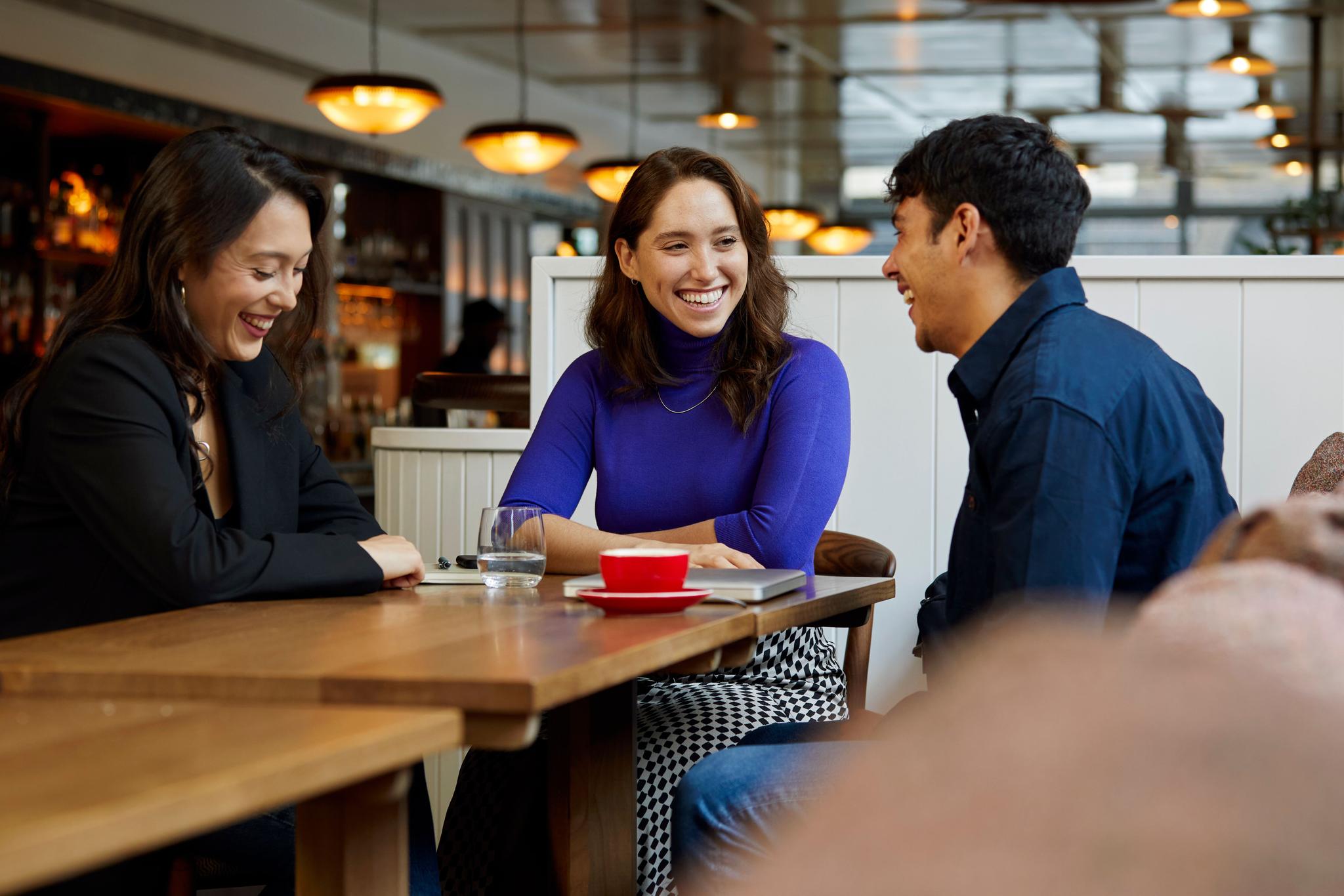 three professionals in a coffee shop