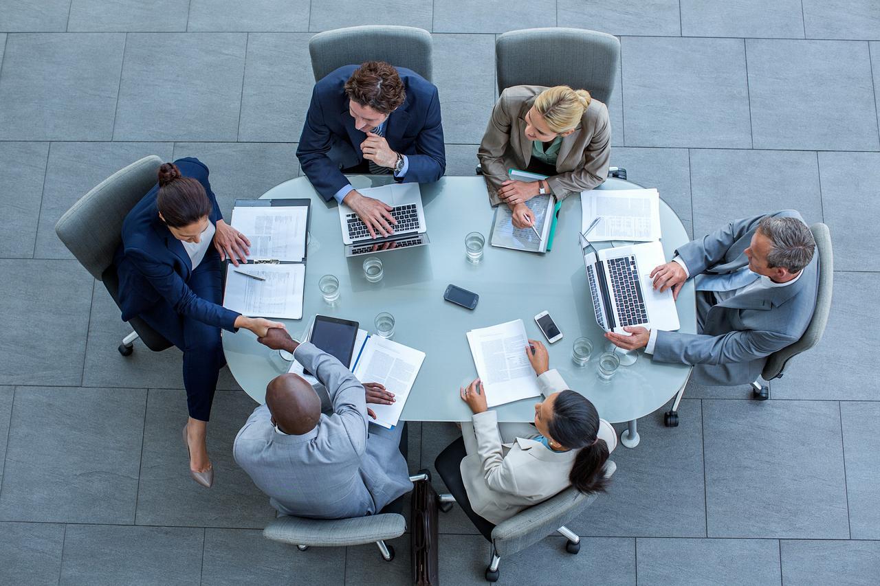 Business people or board directors around a conference table