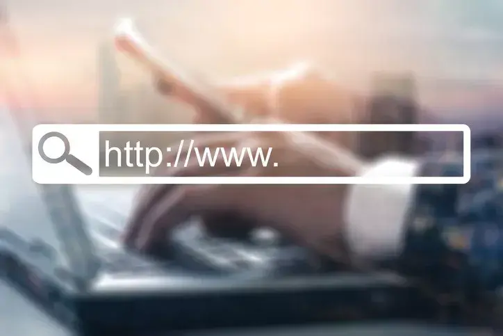 A professional typing on a laptop signifying the importance of an effective government website.