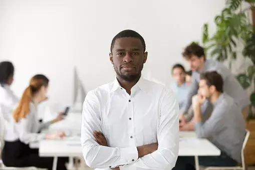 An audit professional with his colleagues in the background discussing the role of the audit committee.