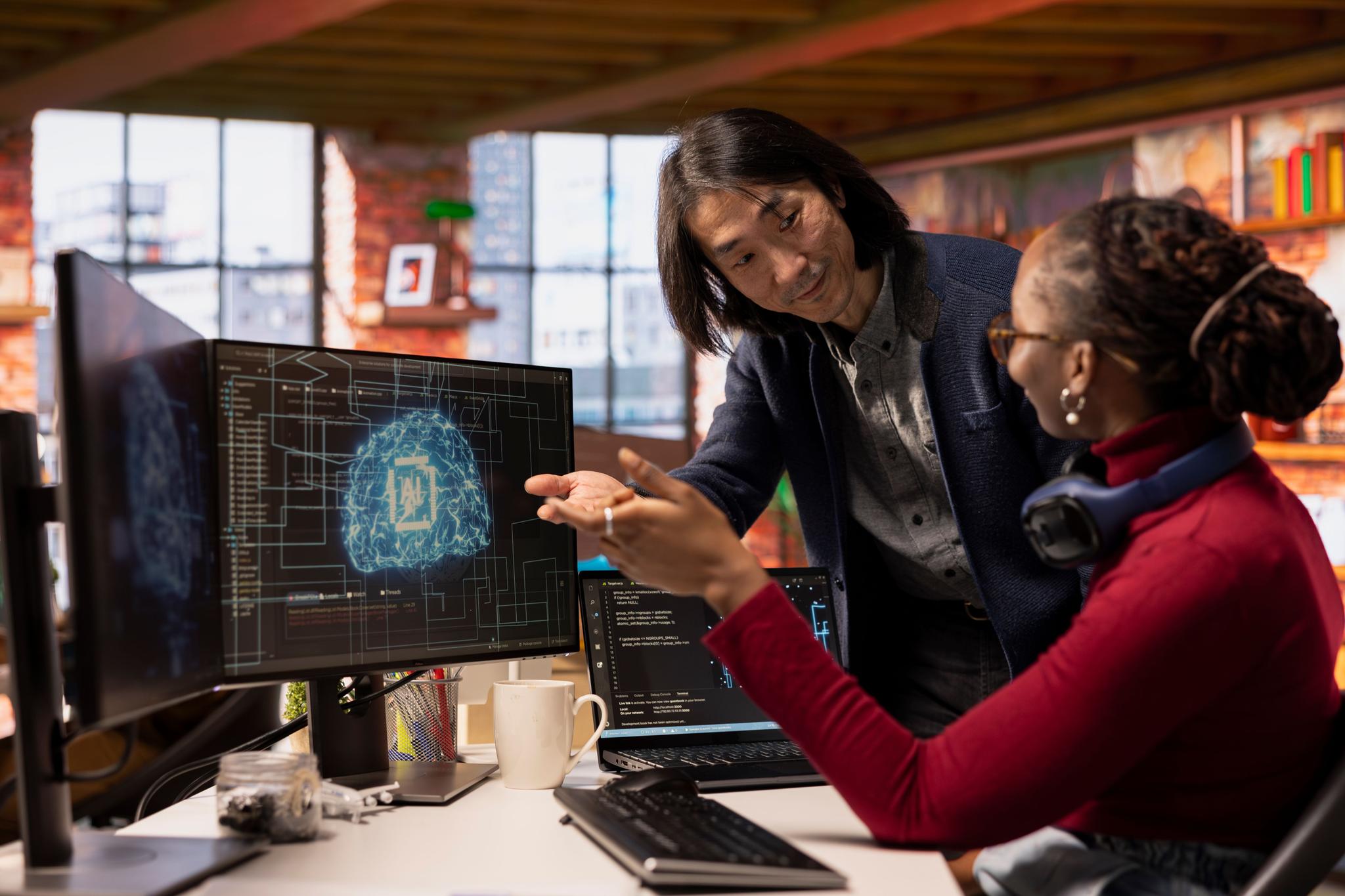 Team leader overseeing work done by employee in Silicon Valley workplace