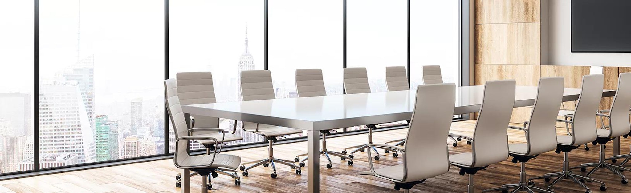 Image of a boardroom where colleagues use audit management software