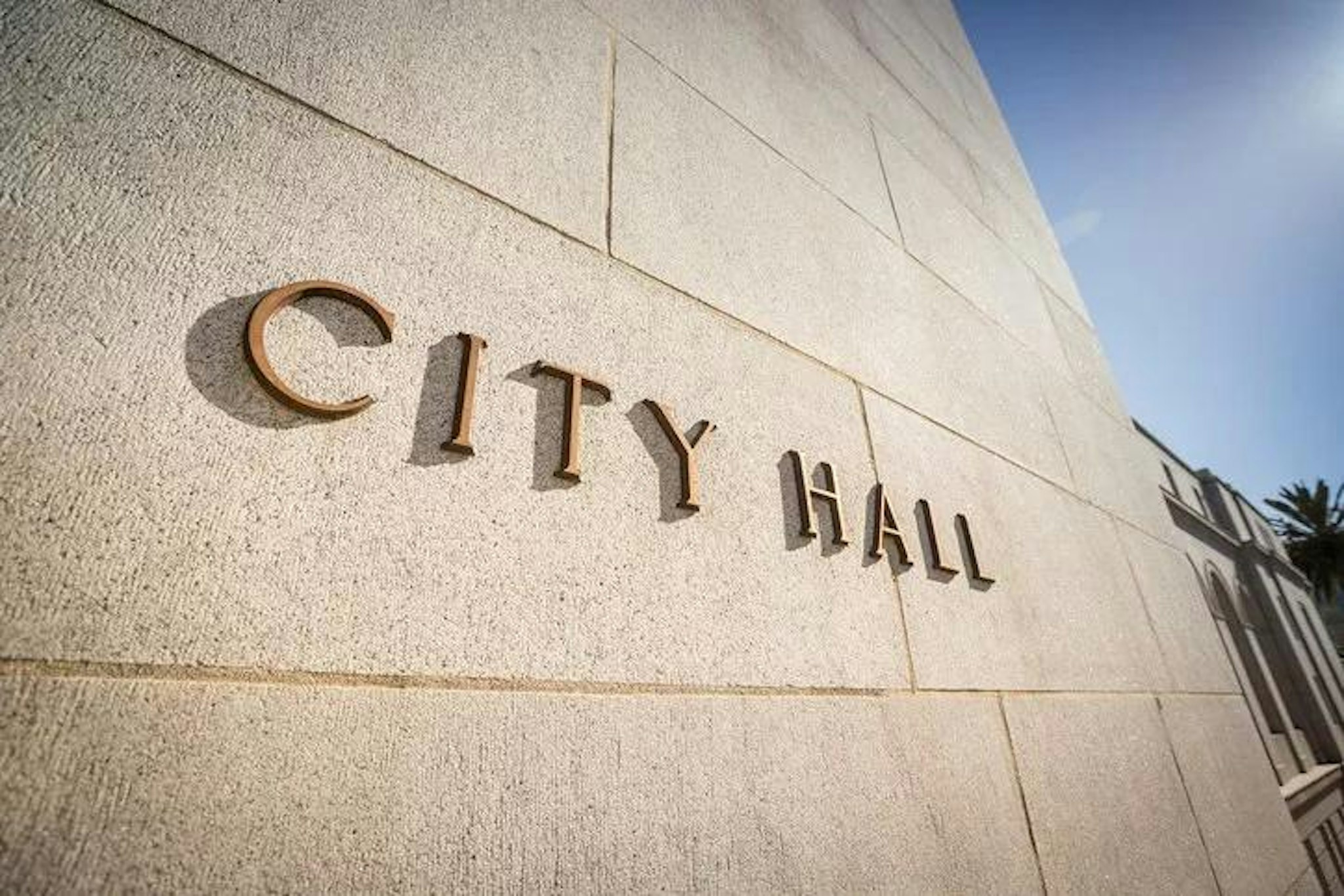 Image of building with "city hall" sign on the front.
