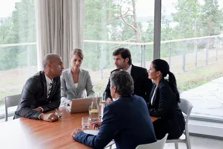 A group of individuals seated around a boardroom table