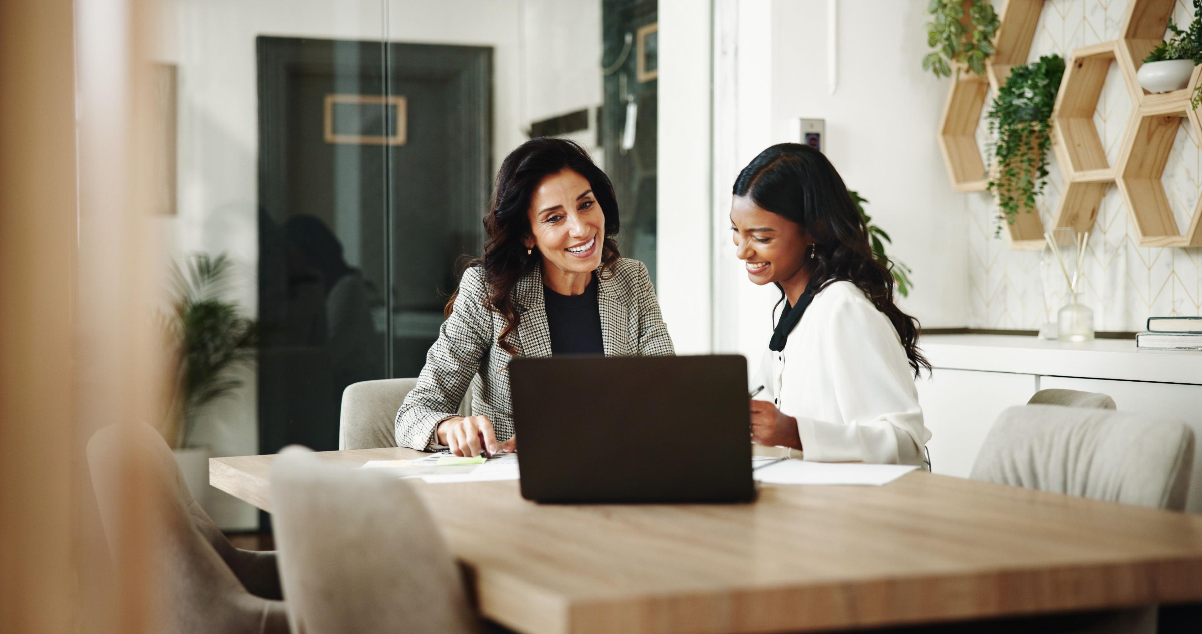 Two audit professionals discussing ai in internal audit