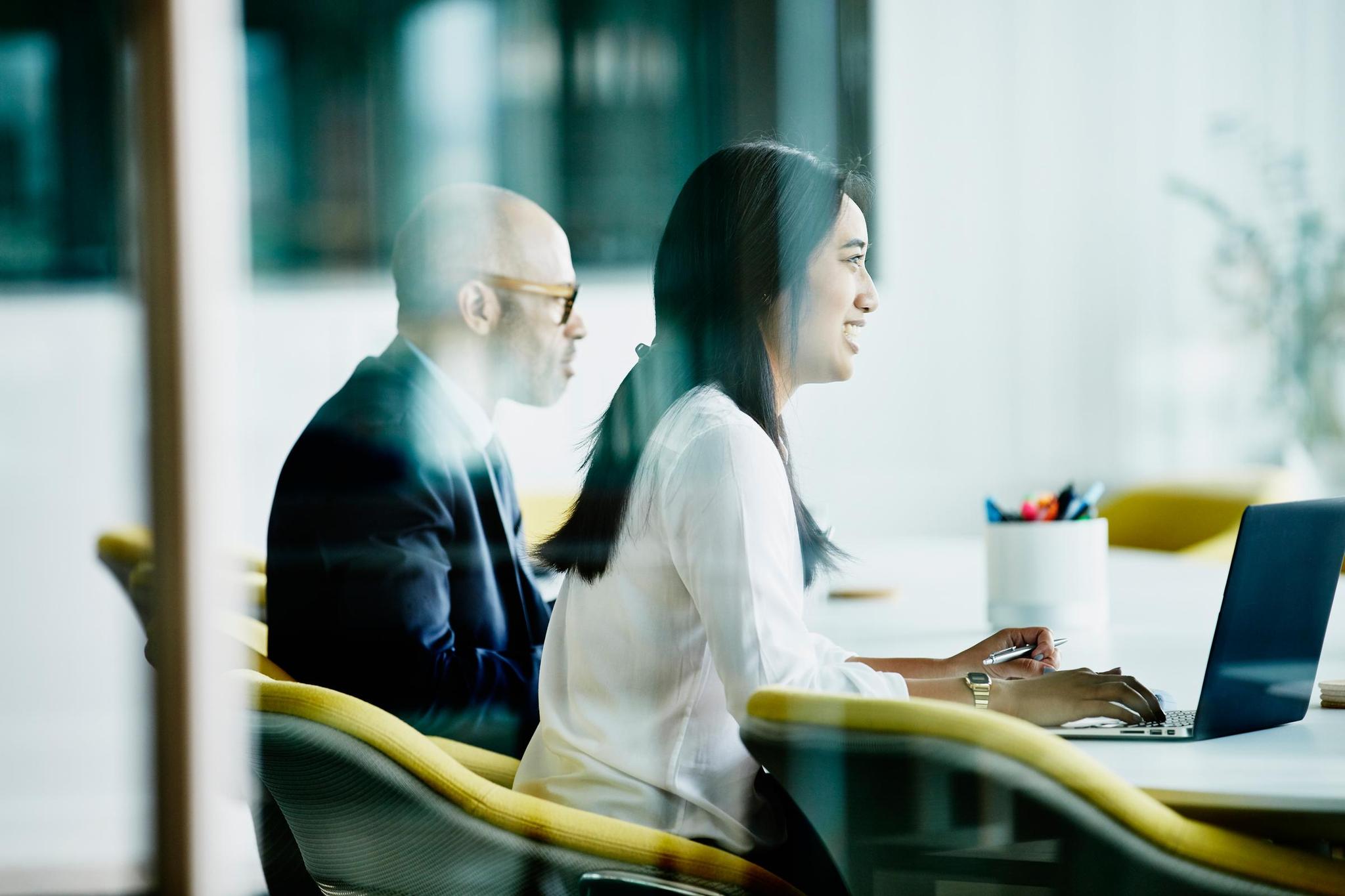 Person writes corporate minutes in meeting