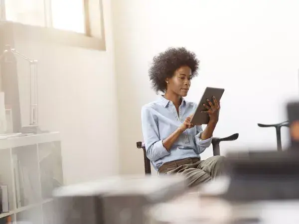 Woman reading about the importance of ISO compliance for her company