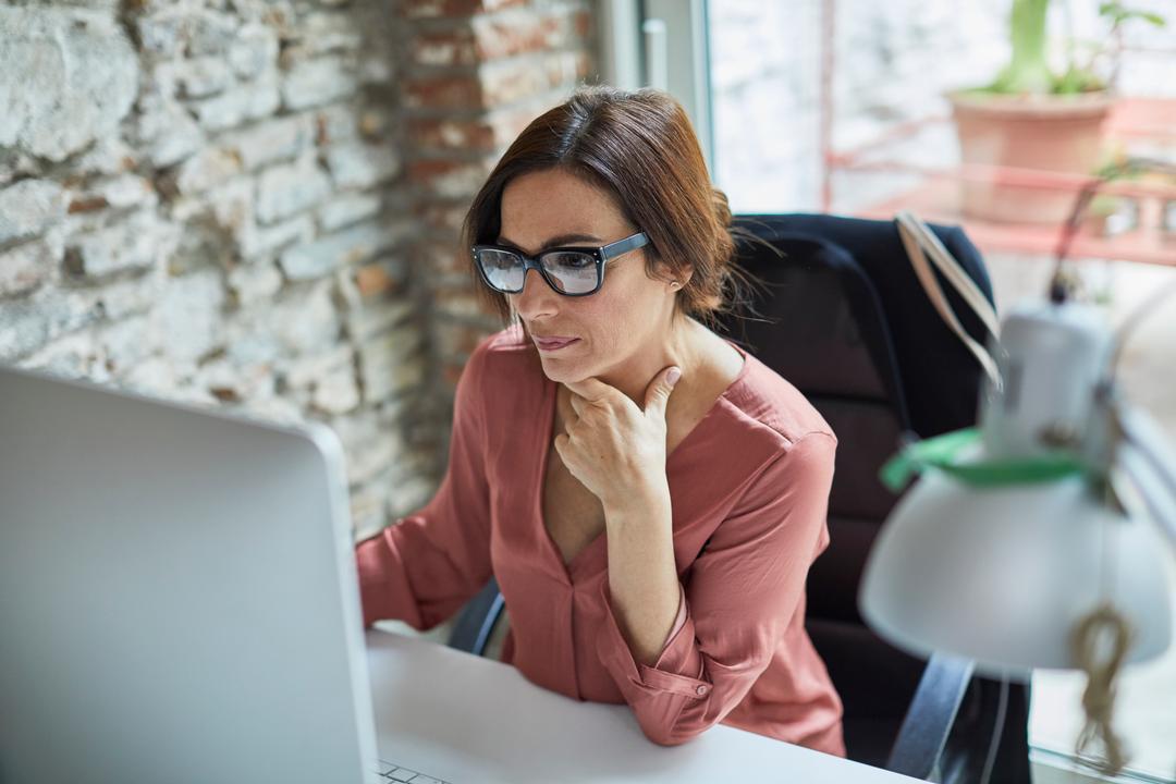 Image of woman researching regulatory compliance's definition and requirements