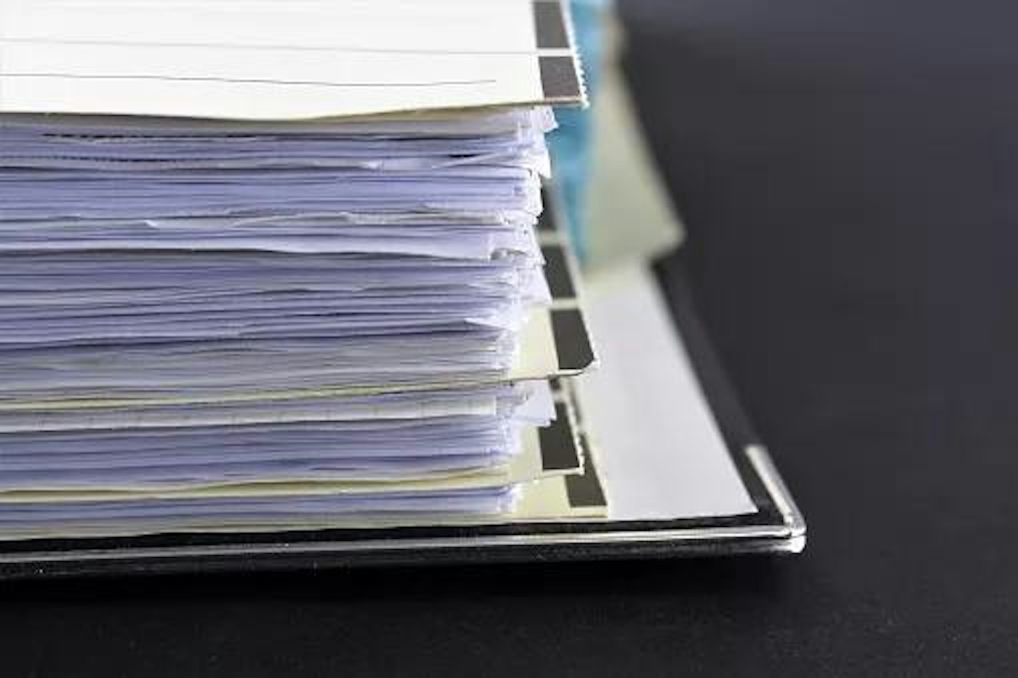 A stack of files signifying the role of the governance department in entity management.