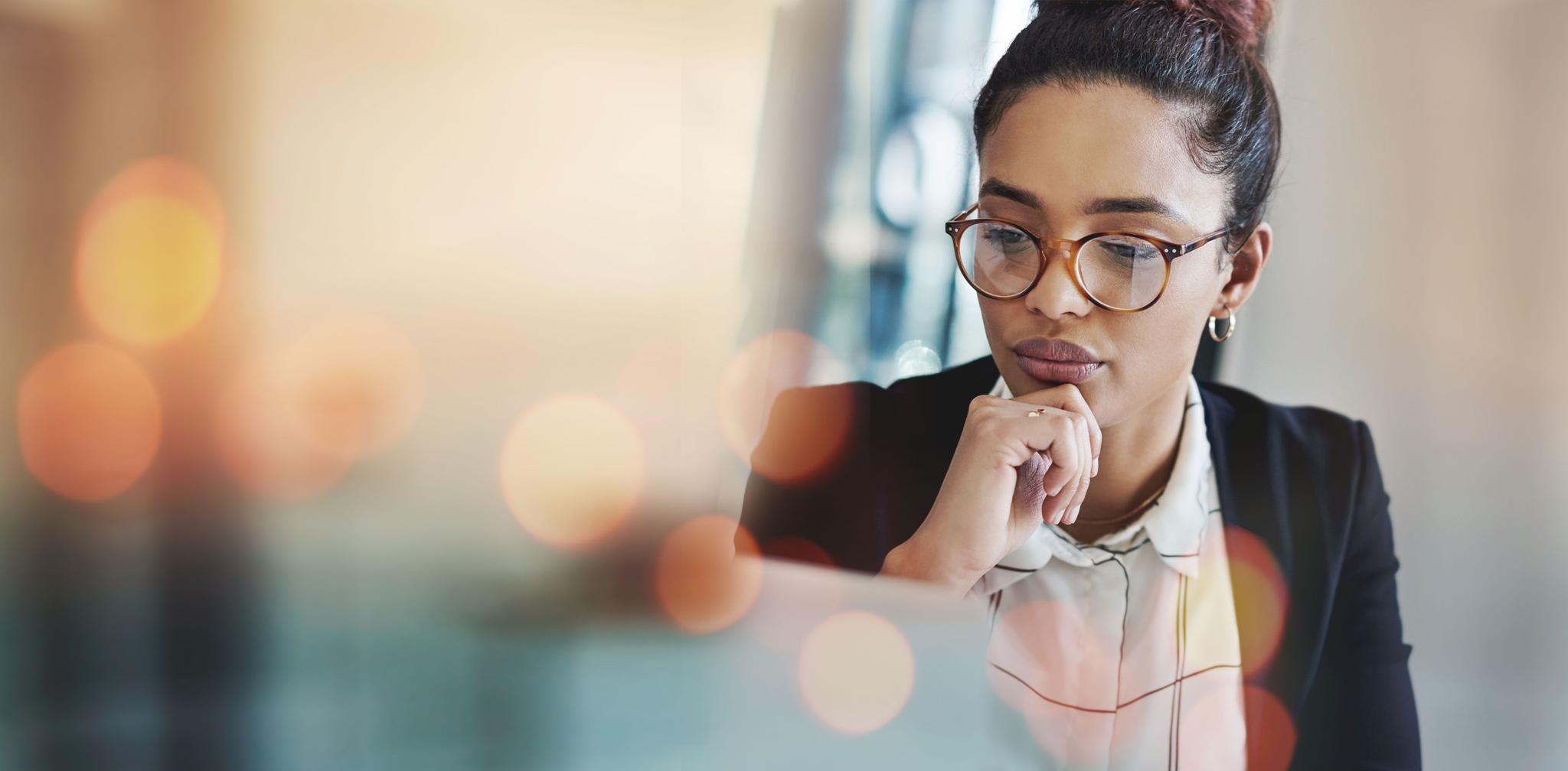 Business woman, thinking and planning on computer