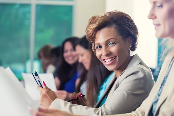 Woman in school board meeting identifying the best way to collaborate with the superintendent