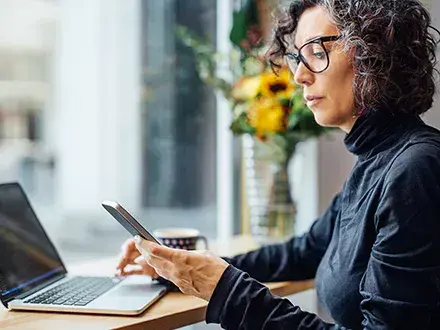 Person on phone practicing policy and procedure management.