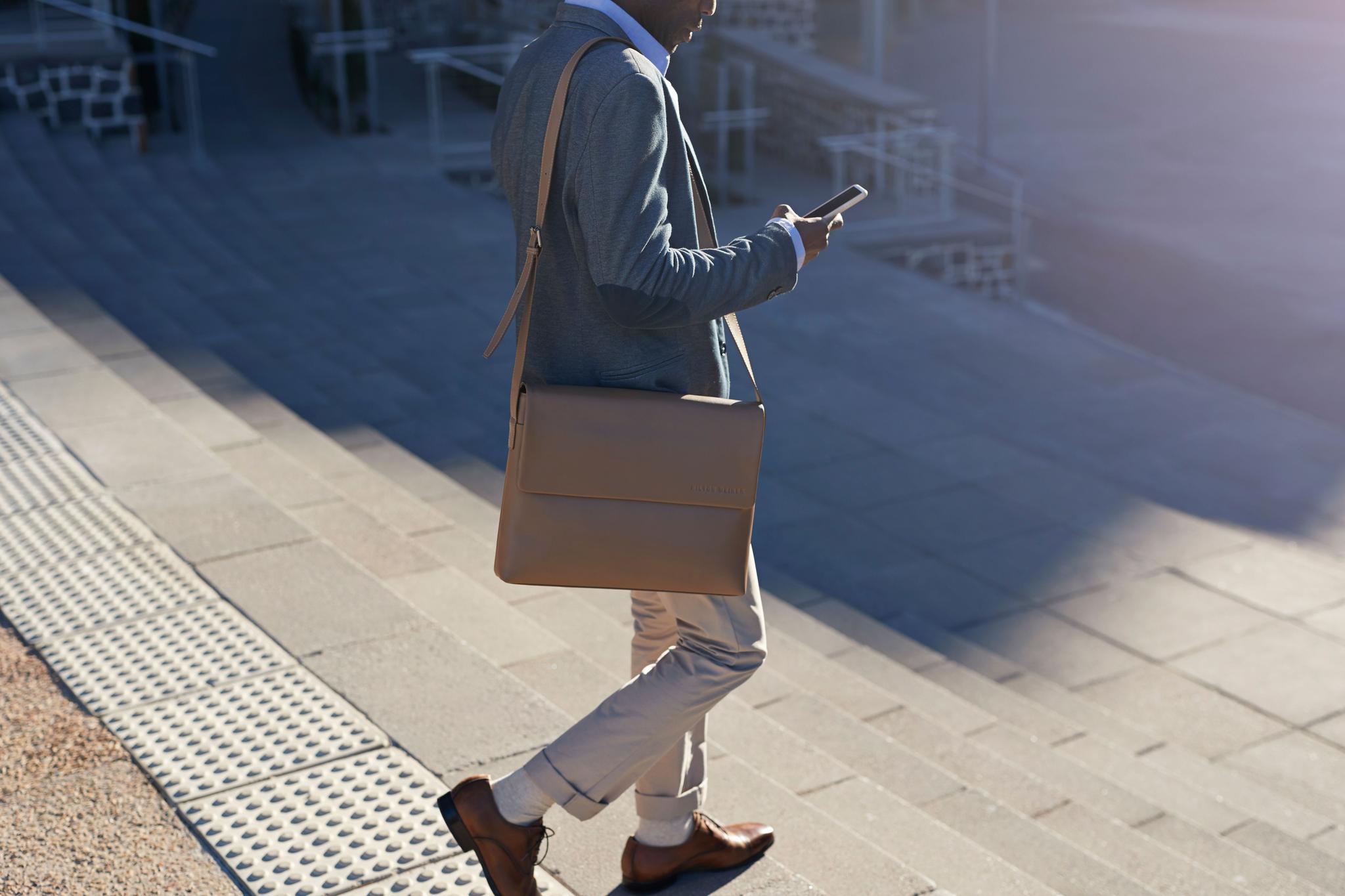 Businessman walking on staircase with bags