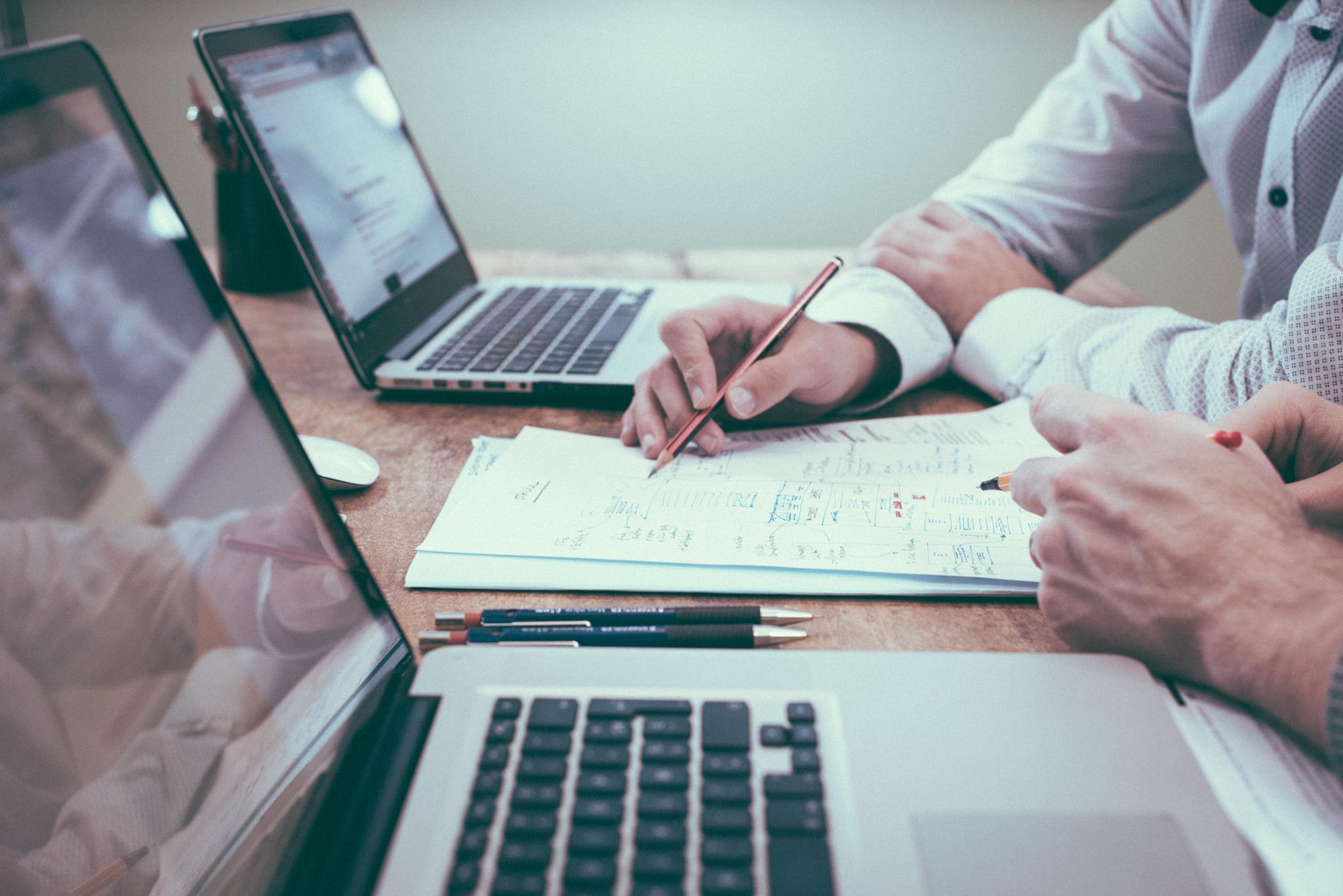 Risk managers on desk with laptop