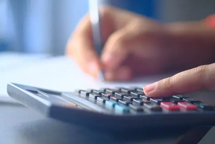 A local government official calculating the budget as part of the local government planning process.