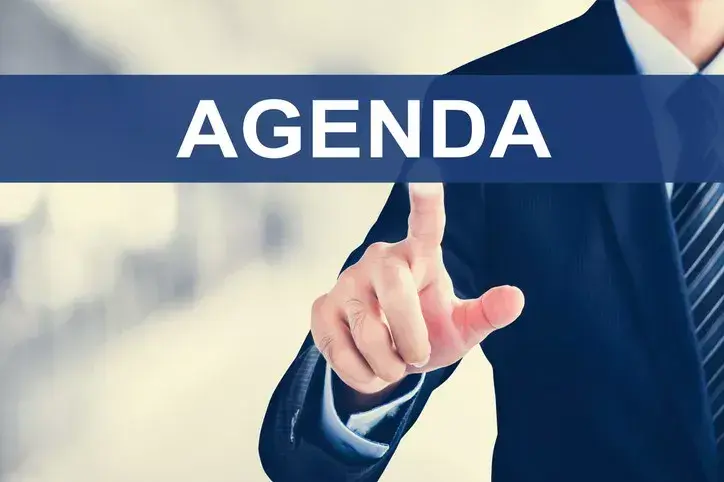 Man selecting banner with the words "agenda" on it.